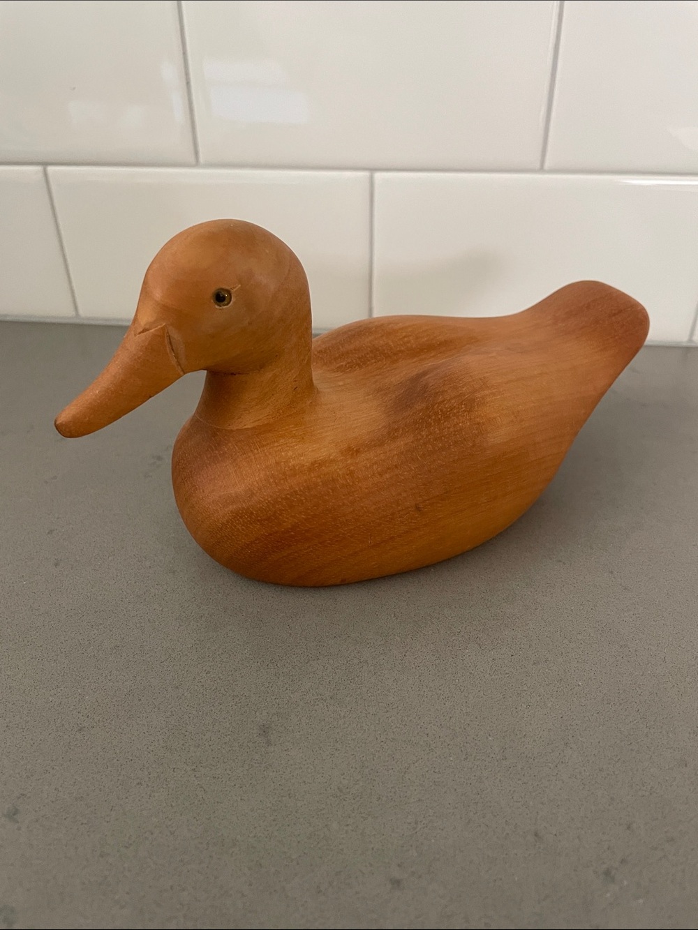Vintage hand-carved wooden duck decoy with glass eyes.